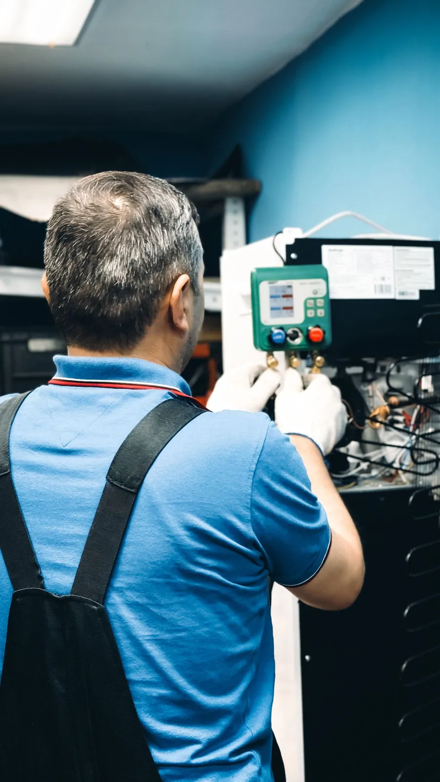 Heating technician performing a seasonal furnace tune-up